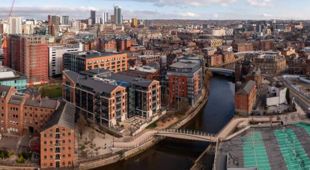 LEEDS, UK - MARCH 29, 2024  An aerial panoramic view of Leeds city centre with the renovated old warehouses providing luxury apartments along the Leeds to Liverpool canal running through Robert's Wharf
