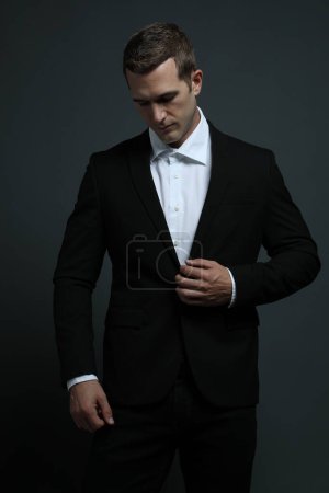 Sexy man in a suit looking down