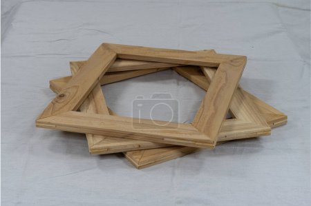 Photo for An offset stack of empty, hand crafted, rectangular, wood photo or picture frames ready to be stained or painted and filled with a piece of artwork. - Royalty Free Image