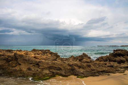 Téléchargez les photos : Plage rocheuse avec ciel nuageux : beauté côtière du Cap Serrat à Bizerte, Tunisie - en image libre de droit