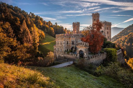 Photo for Latzfons, Italy - Beautiful autumn scenery at Gernstein Castle (Castello di Gernstein, Schloss Gernstein) at sunrise in South Tyrol with blue sky and golden foliage - Royalty Free Image