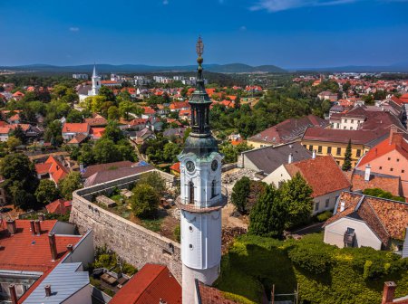 Photo for Veszprem, Hungary - Aerial view of the Fire-watch tower at Ovaros square, castle district of Veszprem with Reformed Church and medieval buildings at background on a sunny summer day with clear blue sky - Royalty Free Image