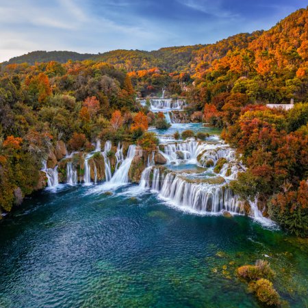 Photo for Krka, Croatia - Aerial panoramic view of the beautiful Krka Waterfalls in Krka National Park on a bright autumn morning with colorful autumn foliage and blue sky - Royalty Free Image