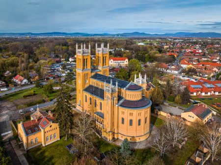 Photo for Fot, Hungary - Aerial view of the Roman Catholic Church of the Immaculate Conception (Szeplotlen Fogantatas templom) in the town of Fot on a sunny spring day with blue sky - Royalty Free Image
