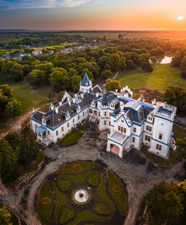 Photo for Nadasdladany, Hungary - Aerial panoramic view of the beautiful Nadasdy Mansion (Nadasdy-kastely) at the small village of Nadasdladany with rising sun, warm sunlight and blue sky on a summer morning - Royalty Free Image