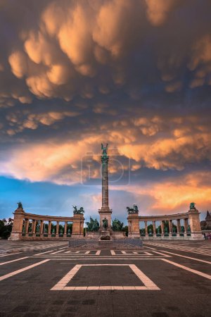 Photo for Budapest, Hungary - Unique mammatus clouds over Heroes' Square Millennium Monument at Budapest after a heavy thunderstorm on a summer afternoon sunset with warm golden colors - Royalty Free Image