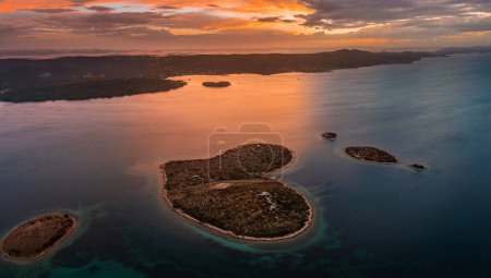 Photo for Galesnjak, Croatia - Aerial panoramic view of the beautiful heart-shaped island Galesnjak with a colorful golden summer sunset above the Adriatic mediterranean sea in Dalmatia region - Royalty Free Image