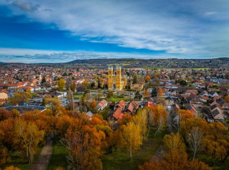 Photo for Fot, Hungary - Aerial view of the Roman Catholic Church of the Immaculate Conception (Szeplotlen Fogantatas templom) and the town of Fot on a sunny autumn day with autumn foliage and blue sky and clouds - Royalty Free Image