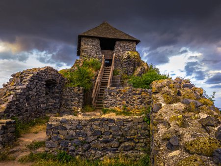 Photo for Salgotarjan, Hungary - Salgo Castle (Salgo vara) in Nograd county with dark storm clouds above at sunset - Royalty Free Image