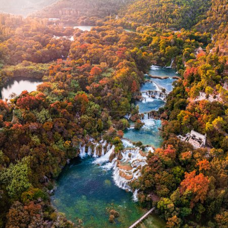 Photo for Krka, Croatia - Aerial panoramic view of the famous Krka Waterfalls in Krka National Park on a sunny autumn morning with colorful autumn foliage sunlight - Royalty Free Image