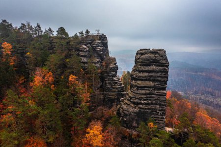 Hrensko, Czech Republic - Aerial view of the unique rock formations of Bohemian Switzerland National Park on a foggy autumn day