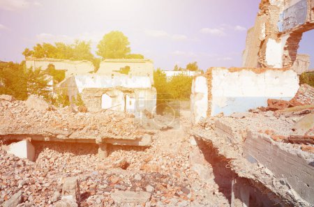 Photo for Collapsed industrial multistorey building in daytime. Disaster scene full of debris, broken bricks and damaged non residental house. Concept of war action aftermath or building demolition - Royalty Free Image