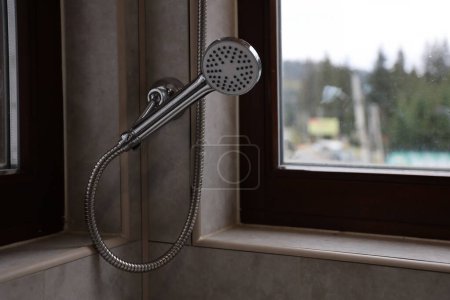 Photo for Silvery shower in modern hotel bathroom with natural light from window - Royalty Free Image
