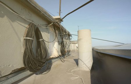 Photo for Amplify tv and internet system coaxial cables and fiber optic cable hanging in roll on residental roof top. - Royalty Free Image