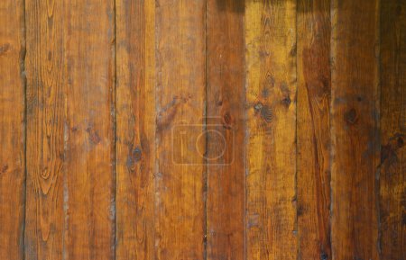 Photo for Texture of the old wooden wall from a number of scratched planks that are varnished - Royalty Free Image