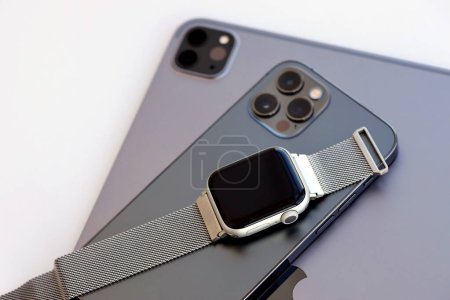 Photo for KYIV, UKRAINE - 4 MAY, 2023: Apple brand devices iphone, ipad with apple watch lies on macbook body close up - Royalty Free Image