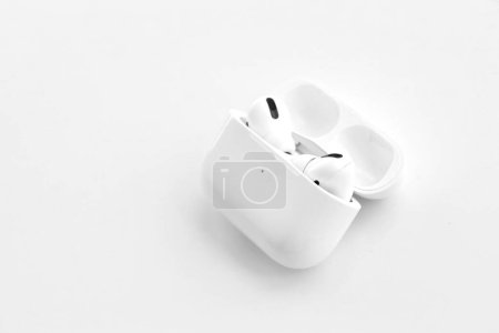 Photo for KYIV, UKRAINE - 4 MAY, 2023: Apple AirPods Pro on a white background. Wireless headphones in a charging case close-up - Royalty Free Image