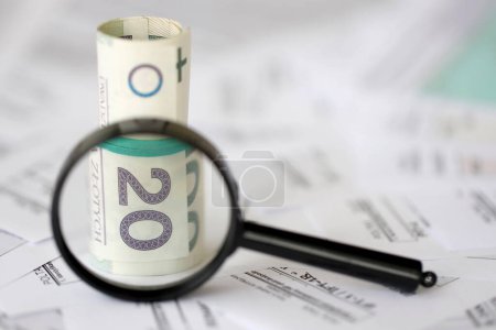 Photo for Polish zloty money and magnifying glass on big amount of polish tax forms close up. Accounting, bureaucracy and taxpayers routine in Poland - Royalty Free Image