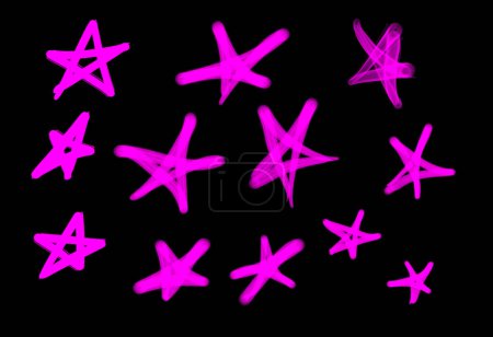 Foto de Colección de etiquetas de graffiti street art con símbolos estrella en color rosa sobre fondo negro - Imagen libre de derechos