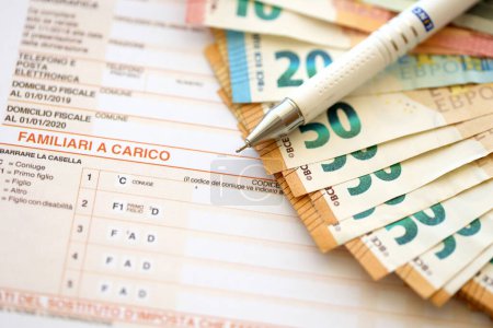 Photo for Filling italian tax form process with pen and euro money bills close up. Tax paying period and deadline - Royalty Free Image