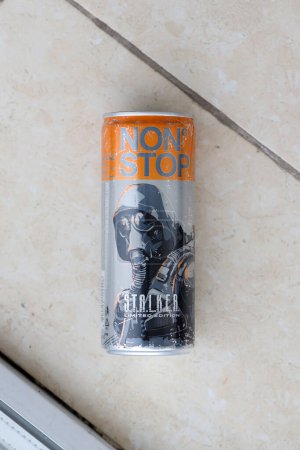Photo for KYIV, UKRAINE - OCTOBER 31, 2023 Non Stop energy drink with limited edition design of Stalker and character with gas mask on aluminium tin can close up - Royalty Free Image