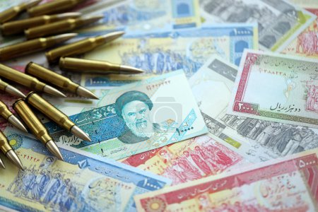 Many bullets and iranian rials money bills close up. Concept of terrorism funding or financial operations to support war in Iran