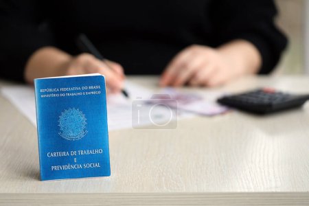 Photo for Brazilian work card and social security blue book lies on accountant or boss table close up - Royalty Free Image