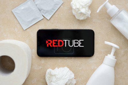 Photo for KYIV, UKRAINE - JANUARY 23, 2024 RedTube adult content website logo on display of iPhone 12 Pro smartphone - Royalty Free Image