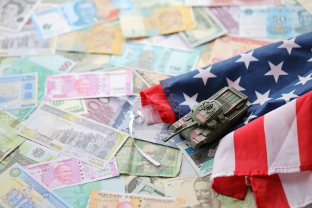 Tank on United States flag on many banknotes of different currency. Background of war funding and military support price for United States of America
