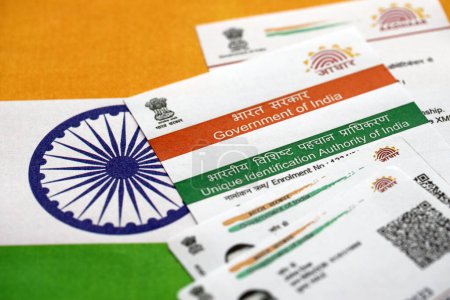 Indian Aadhaar card from Unique Identification Authority of India on Indian flag close up