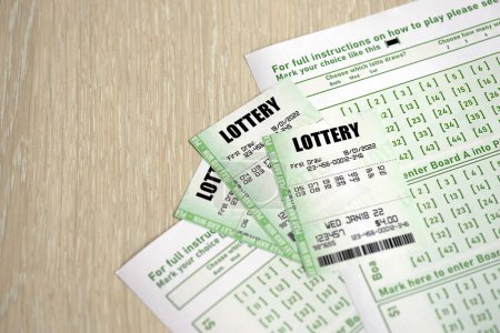 Photo for Green lottery tickets and blank bills with numbers for playing lottery close up - Royalty Free Image