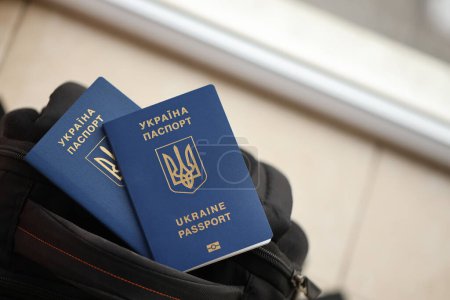 Photo for Two ukrainian biometrical passports on black touristic backpack close up - Royalty Free Image