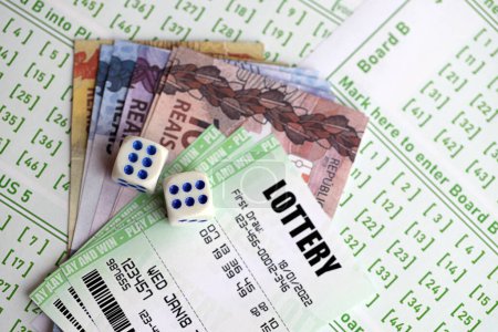 Téléchargez les photos : Billets de loterie verts et brésiliens reals billets d'argent à blanc avec des numéros pour jouer à la loterie fermer - en image libre de droit