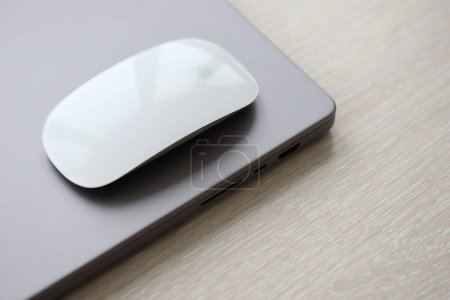 Photo for KYIV, UKRAINE - NOVEMBER 27, 2023 Apple Magic Mouse 3rd generation lies with grey MacBook 2021 close up - Royalty Free Image