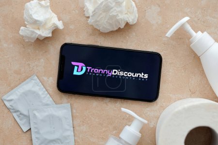 Photo for KYIV, UKRAINE - JANUARY 23, 2024 TrannyDiscounts adult content website logo on display of iPhone 12 Pro smartphone - Royalty Free Image