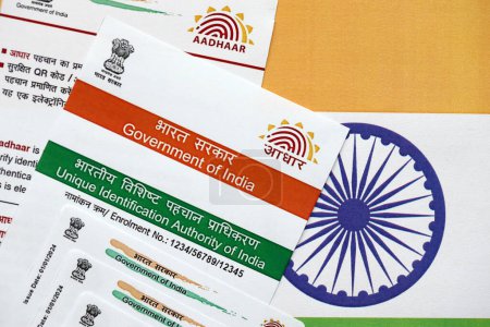 Photo for Indian Aadhaar card from Unique Identification Authority of India on Indian flag close up - Royalty Free Image