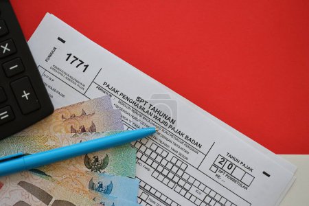 Formulario tributario indonesio 1771 declaración anual del impuesto sobre la renta de los contribuyentes corporativos con pluma se encuentra en la mesa del contable