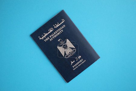 Blue Palestinian Authority passport on blue background close up. Tourism and citizenship concept
