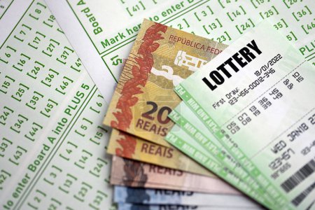 Grüne Lotterielose und brasilianische Reals Geldscheine auf Blanko mit Zahlen für Lotterie aus nächster Nähe