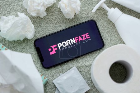 Photo for KYIV, UKRAINE - JANUARY 23, 2024 PornFaze adult content website logo on display of iPhone 12 Pro smartphone - Royalty Free Image