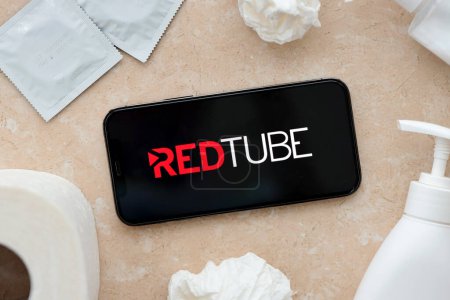 Photo for KYIV, UKRAINE - JANUARY 23, 2024 RedTube adult content website logo on display of iPhone 12 Pro smartphone - Royalty Free Image
