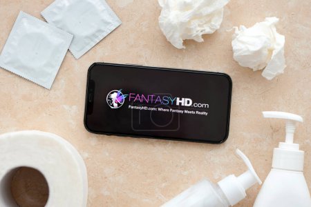 Photo for KYIV, UKRAINE - JANUARY 23, 2024 FantasyHD adult content website logo on display of iPhone 12 Pro smartphone - Royalty Free Image