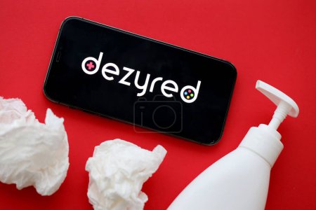 Photo for KYIV, UKRAINE - JANUARY 23, 2024 Dezyred adult content website logo on display of iPhone 12 Pro smartphone - Royalty Free Image