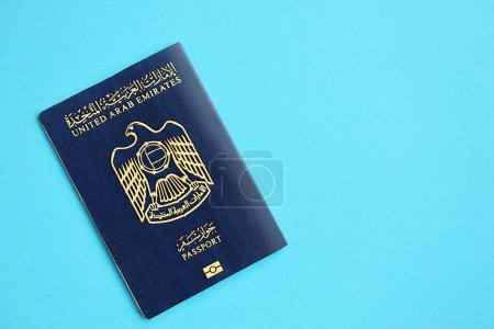 Blue United Arab Emirates passport on blue background close up. Tourism and citizenship concept