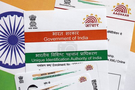 Photo for Indian Aadhaar card from Unique Identification Authority of India on Indian flag close up - Royalty Free Image