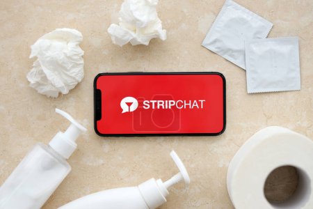 Photo for KYIV, UKRAINE - JANUARY 23, 2024 StripChat adult content website logo on display of iPhone 12 Pro smartphone - Royalty Free Image