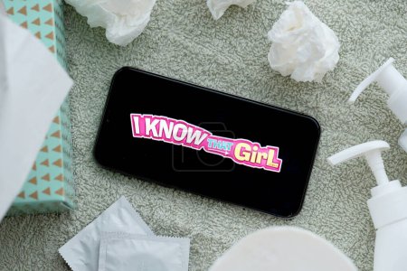 Photo for KYIV, UKRAINE - JANUARY 23, 2024 IKnowThatGirl adult content website logo on display of iPhone 12 Pro smartphone - Royalty Free Image