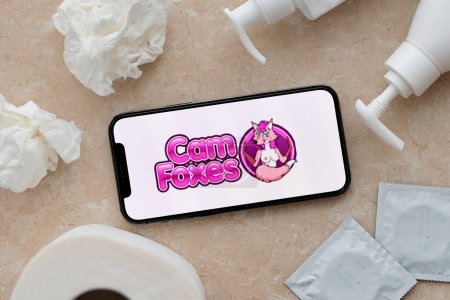 Photo for KYIV, UKRAINE - JANUARY 23, 2024 CamFoxes adult content website logo on display of iPhone 12 Pro smartphone - Royalty Free Image