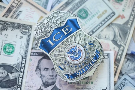 Foto de KYIV, UCRANIA - 9 de marzo de 2024 US ICE Insignia oficial en muchos billetes de dólar estadounidense de cerca - Imagen libre de derechos
