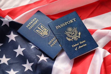 Photo for United States of America and Ukrainian Passports on folded US flag close up - Royalty Free Image